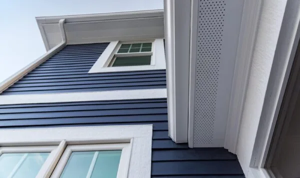 Image of navy James Hardie fiber cement siding and overhang.