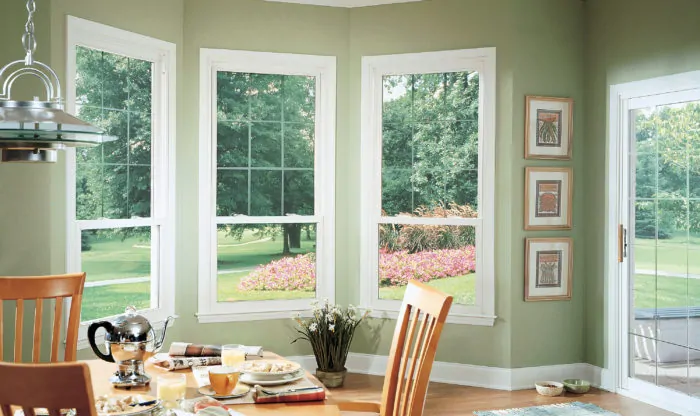Sliding patio doors and 3 double-hung window in kitchen
