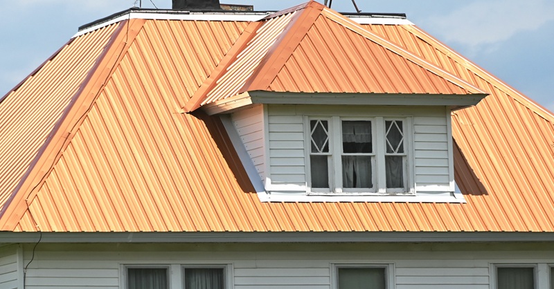 Home With a Copper Roof and White Siding